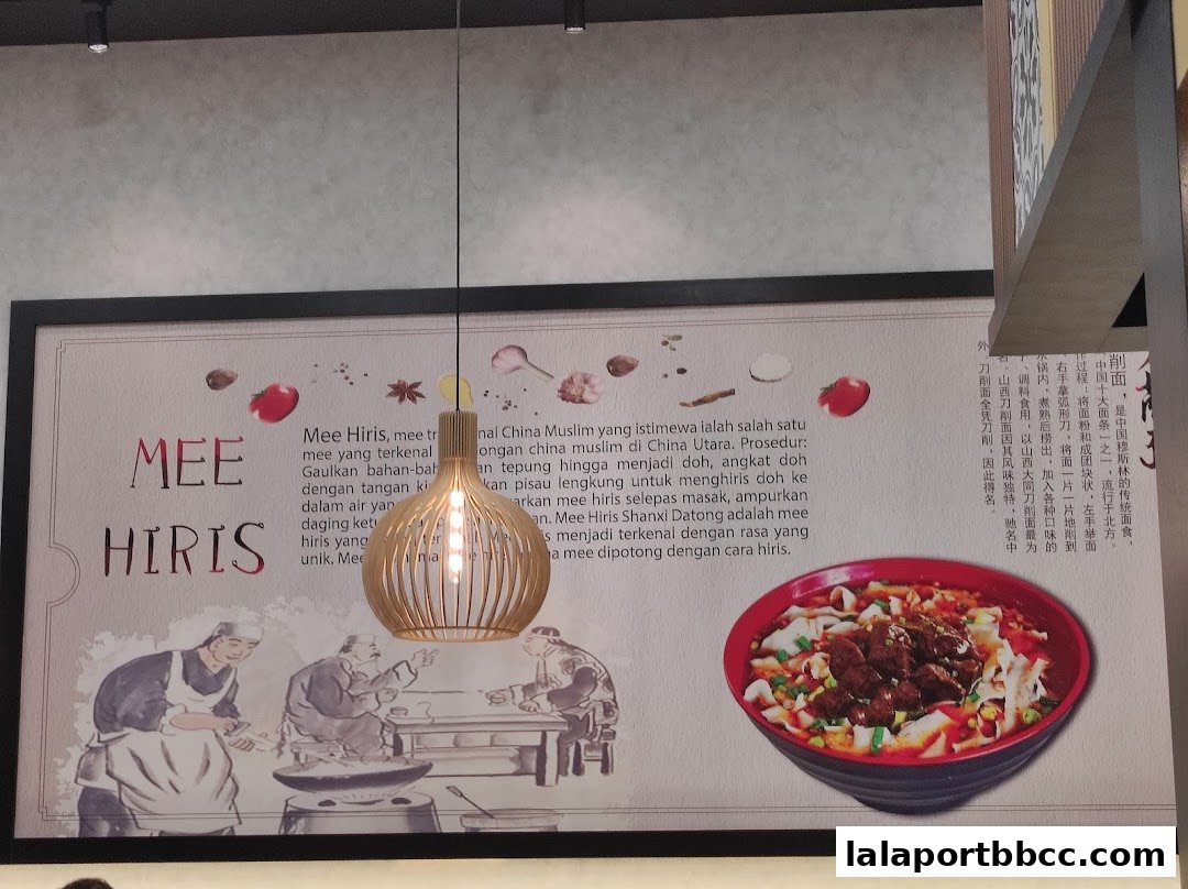 A decorative wall panel for Mee Hiris restaurant featuring text and illustrations of food preparation and a bowl of noodles.