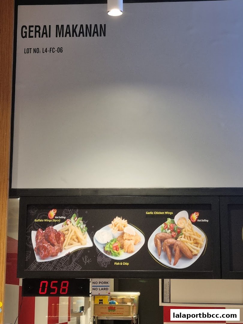 A food stall menu displaying Buffalo Wings, Fish & Chip, and Garlic Chicken Wings.