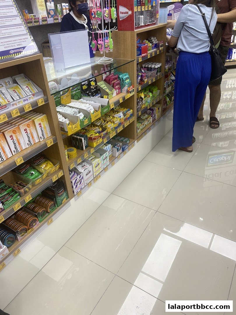Interior view of a pharmacy with shelves stocked with health and personal care products.