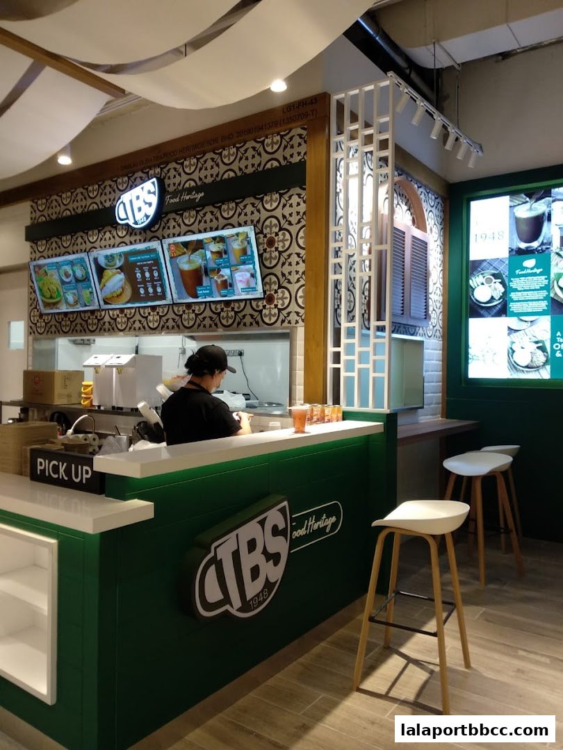 Interior view of a modern food counter with digital menus and seating.