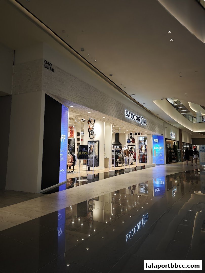 The Sacoor Brothers LaLaport BBCC shop front with clothing displays and promotional signage.