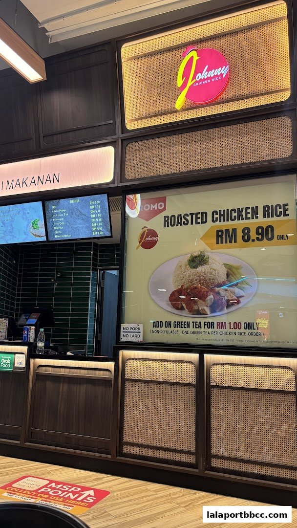 The Johnny Chicken Rice shop front with a promotional poster for roasted chicken rice.