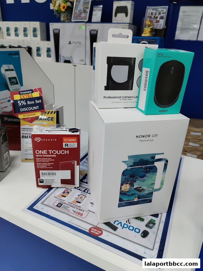 Various electronic products and accessories displayed on shelves and a counter at a retail store.