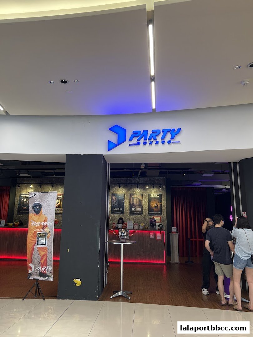 The entrance to PartyBox 360, featuring a prominent sign and posters for various attractions.