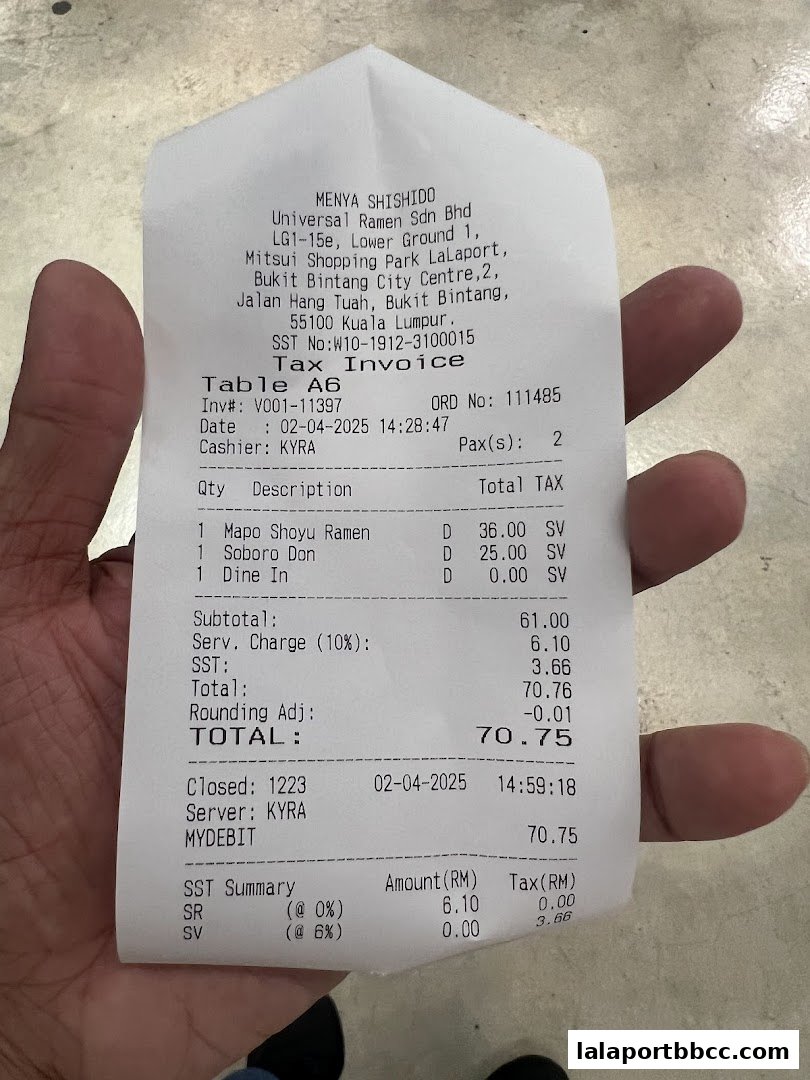 A receipt from Menya Shishido showing ramen and other food items with prices and taxes.