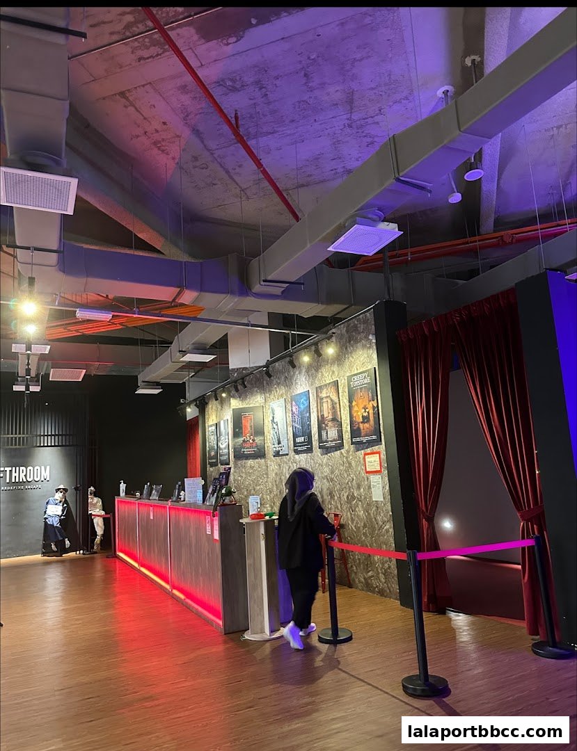 Interior of an escape room venue with a reception desk and themed posters on the wall.