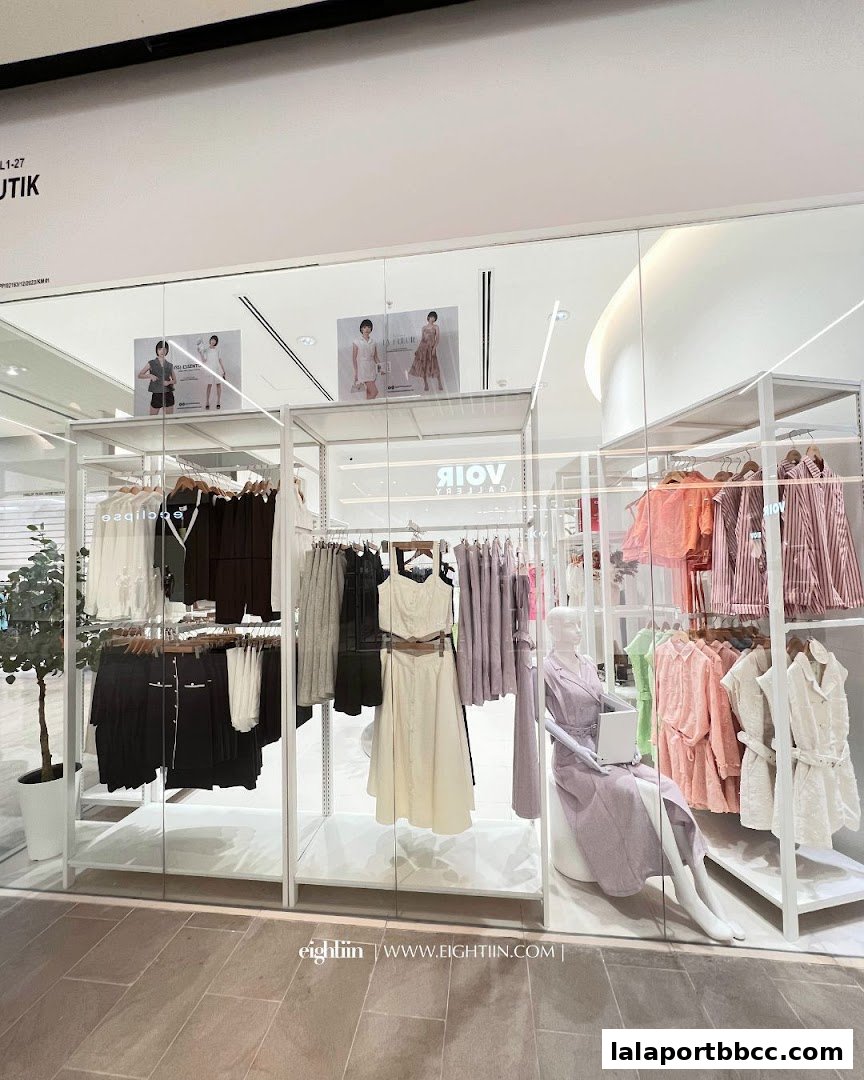 A modern fashion boutique showcasing stylish women's apparel on display racks and mannequins.