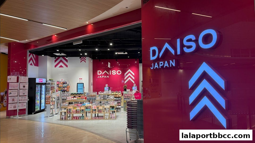 The entrance of a brightly lit DAISO Japan store with shelves of products visible inside.