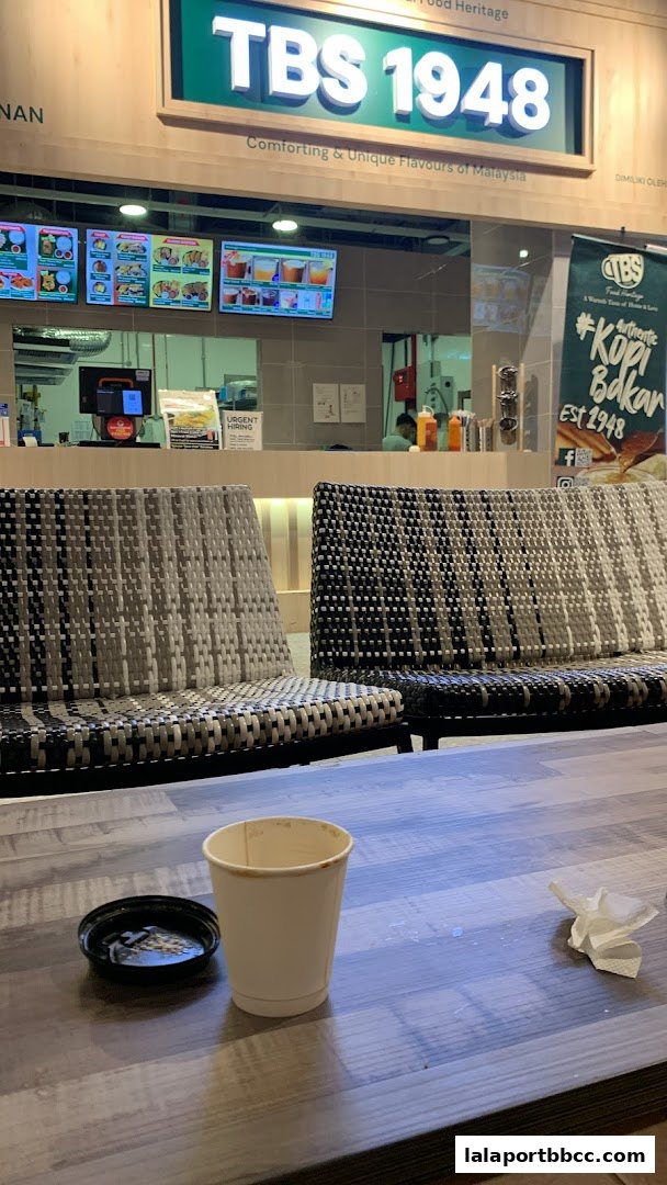 A view of TBS Food Heritage with seating and menu displays.