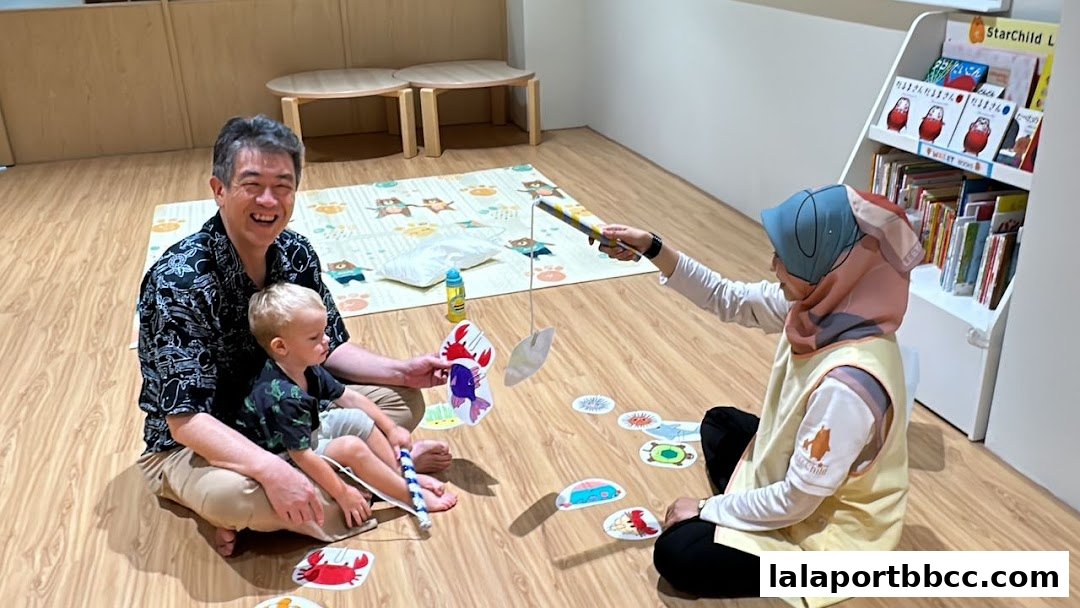 Adults and children engage in a fun fishing game at a child care center.