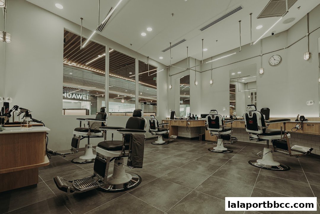 Interior of a modern barbershop with multiple barber chairs and stations.