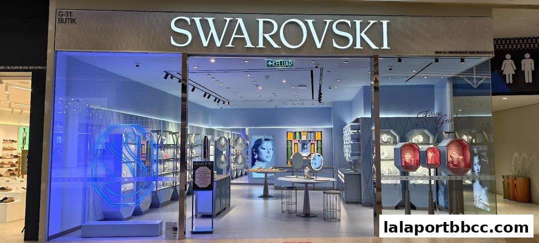 The elegant Swarovski store features a bright, modern interior with sparkling jewelry displays and a prominent brand logo.