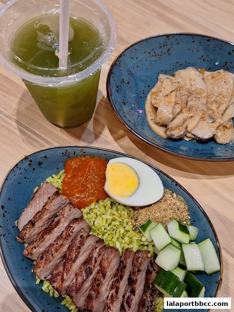 A close-up of a delicious meal featuring grilled meat, rice, egg, and cucumber, with a side of mushrooms and a green drink.