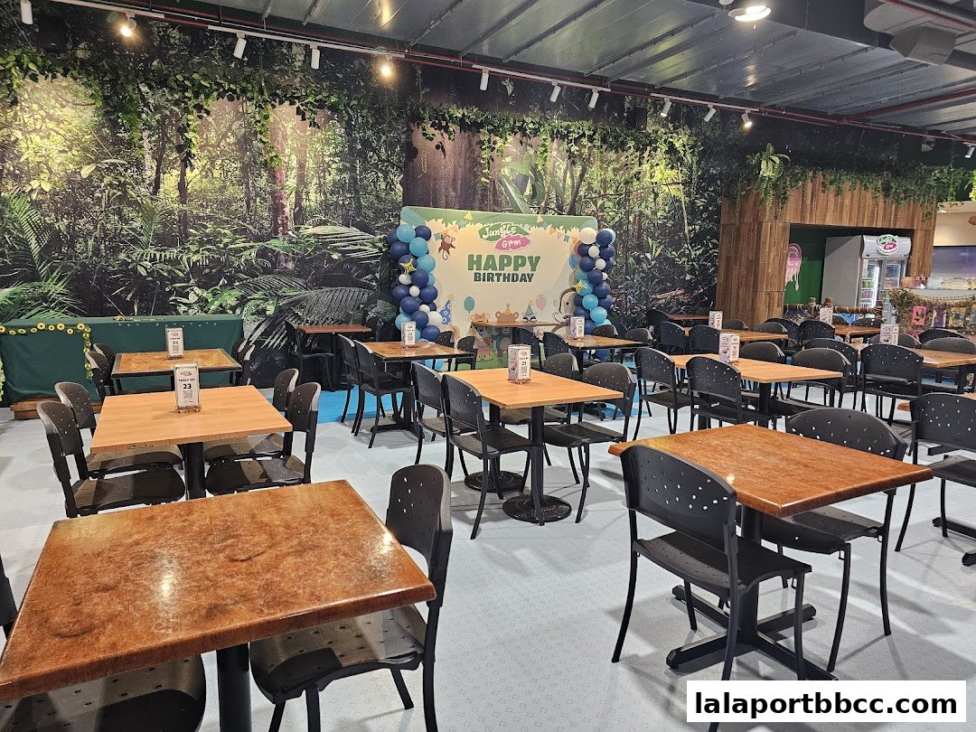 Interior of a restaurant with jungle-themed decor and tables set for a birthday celebration.