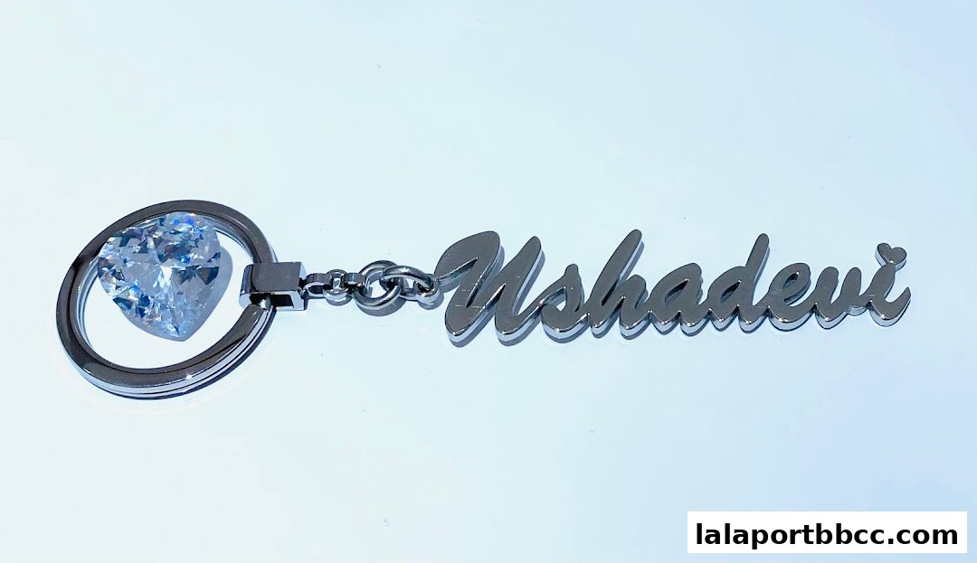 A personalized keychain with a heart-shaped gem and the name Ushadevi.