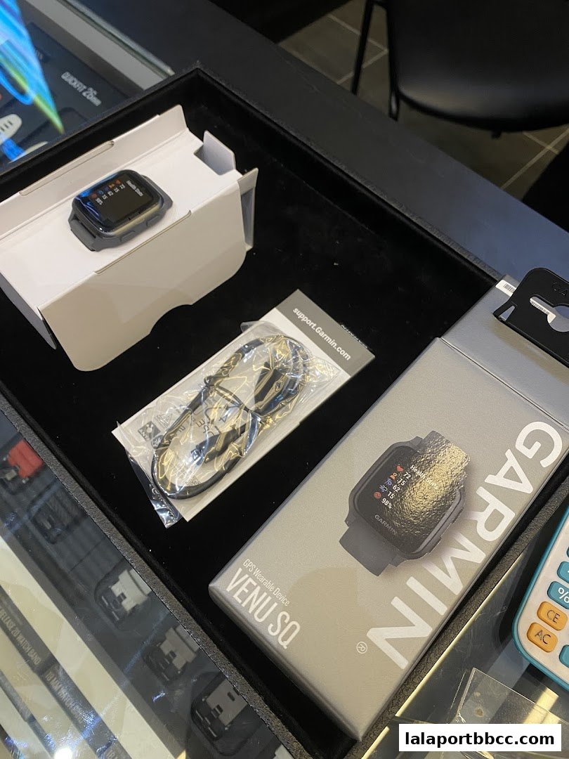 Garmin Venu Sq GPS wearable device and accessories displayed in a retail store.