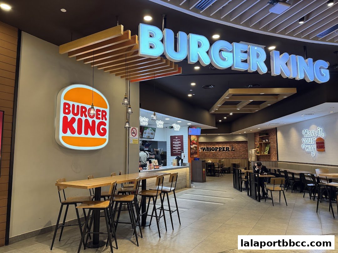 Burger King restaurant interior with seating, counter, and prominent branding.