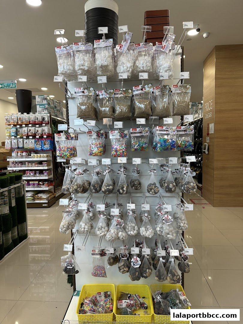 Display of various decorative stones and pebbles in clear bags at MR.DIY PLUS.