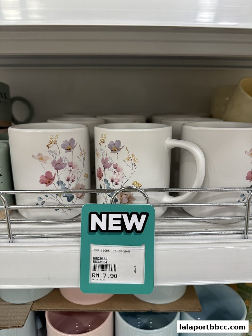 Close-up of new floral mugs displayed on a shelf at MR.DIY PLUS.