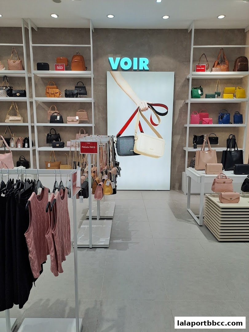 Interior view of a Voir Gallery shop showcasing a wide selection of handbags and apparel.
