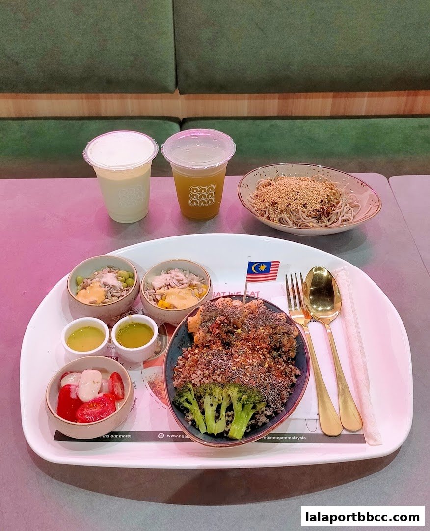 A healthy meal with various bowls of food, drinks, and cutlery on a tray.