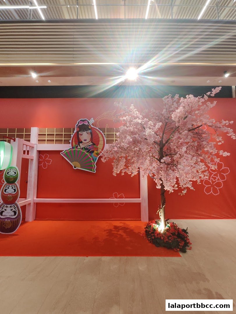 A vibrant Japanese-themed display with a cherry blossom tree and traditional decor.