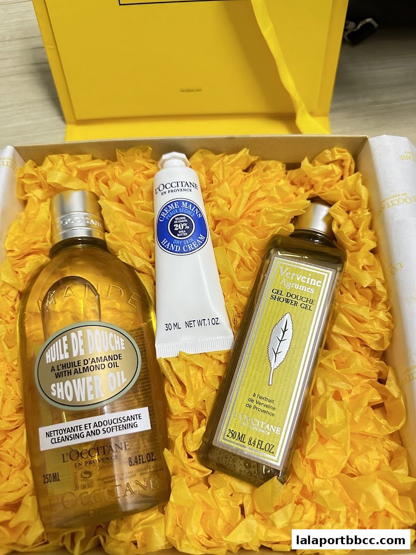 A gift box filled with L'Occitane shower oil, hand cream, and shower gel.