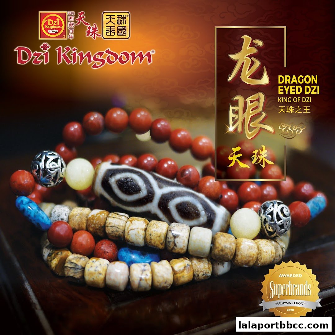 Close-up of Dzi bracelets featuring a prominent Dragon Eye Dzi bead and various other stones.