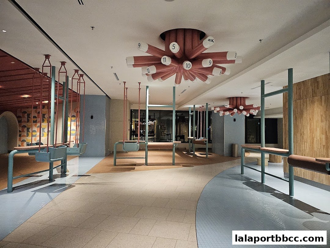 Interior view of a modern space with swings and unique ceiling light fixtures.
