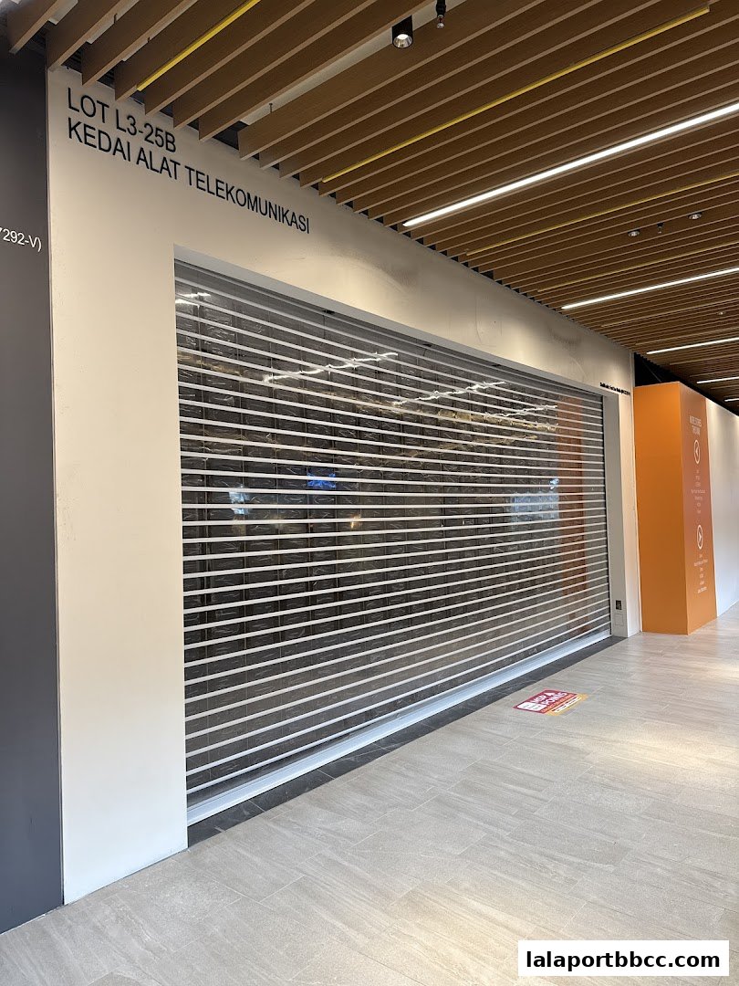 A closed Xiaomi store with a rolling shutter and signage indicating it's a telecommunications equipment shop.