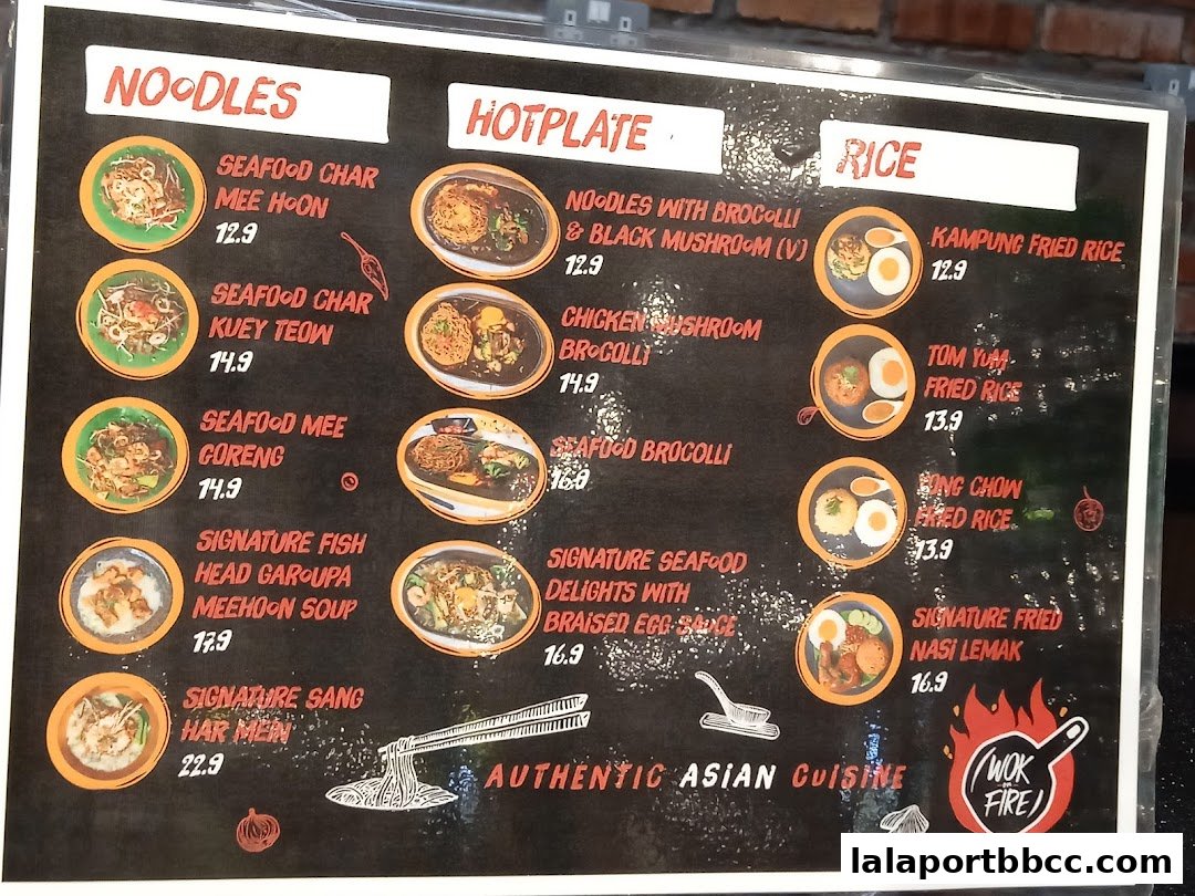 A menu board for Wok On Fire featuring noodles, hotplate dishes, and rice options.