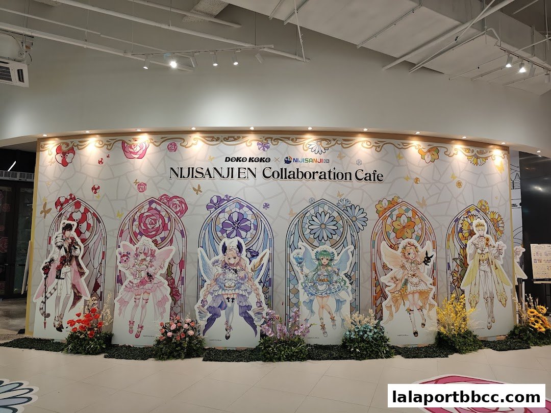 Doko Koko NIJISANJI EN Collaboration Cafe with character standees and floral decorations.