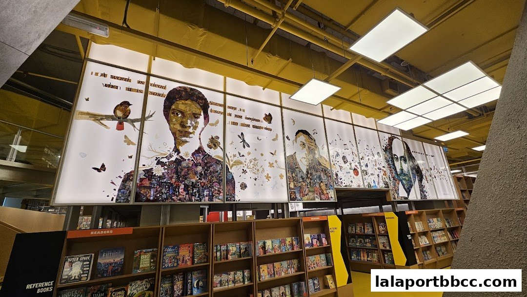 Interior view of BookXcess LaLaport with bookshelves and artistic wall displays.
