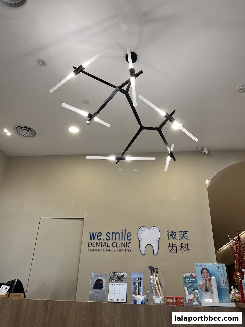 Interior shot of WeSmile Dental Clinic with a modern chandelier and reception desk.