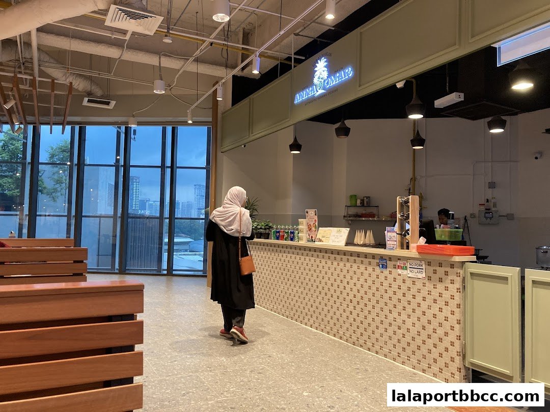Interior view of Auntie Anna Pak Cik Omar restaurant with a customer at the counter.