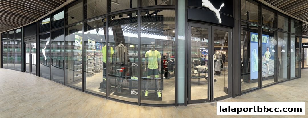The exterior of a PUMA store with large glass windows displaying athletic wear and mannequins.