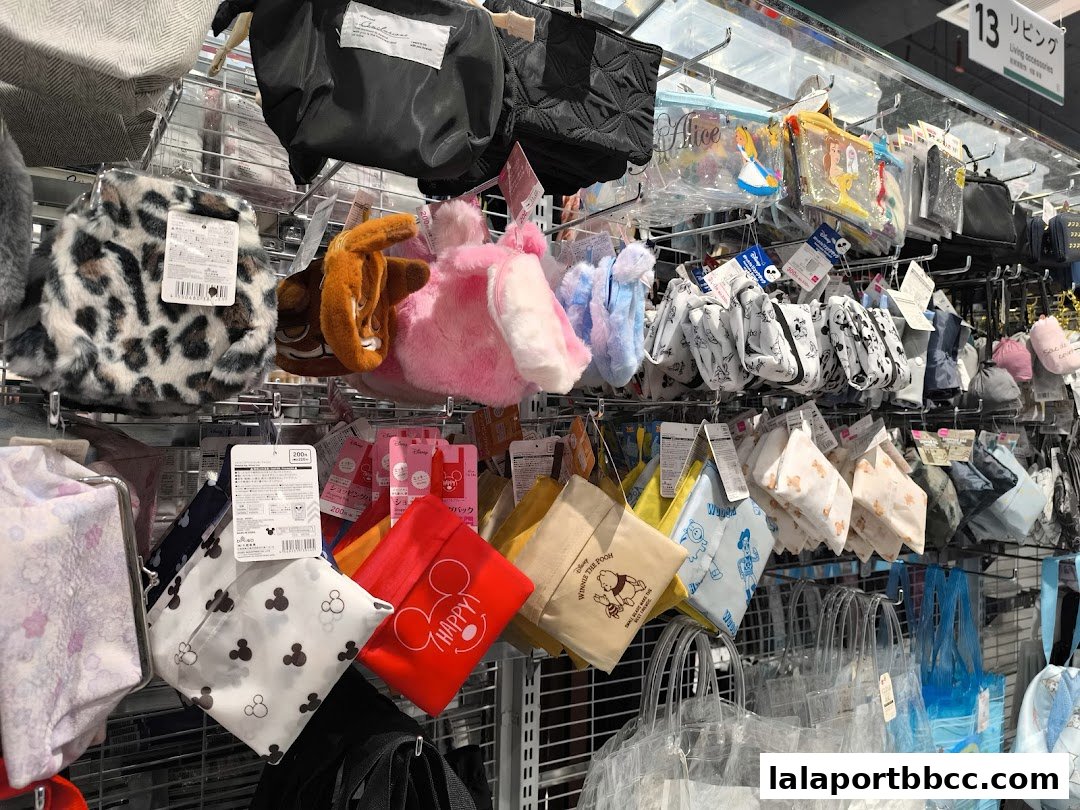 A display of various pouches and bags, many featuring Disney characters, in a retail store.