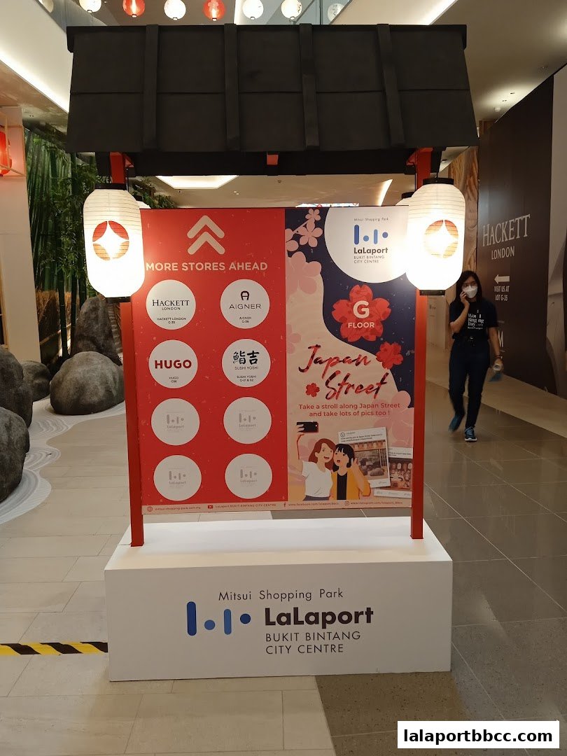 A sign for Japan Street at LaLaport BBCC, showcasing various stores and a photo opportunity.