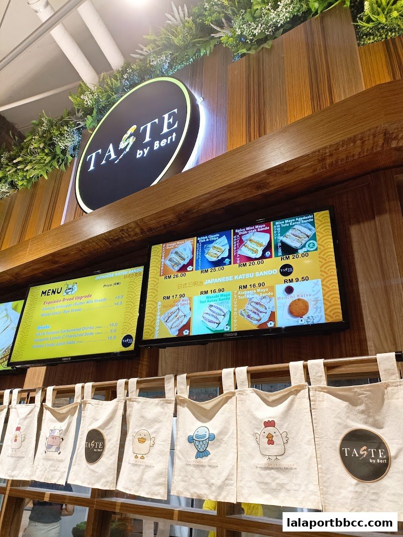 A food court stall with a menu displaying Japanese Katsu Sando and drinks.