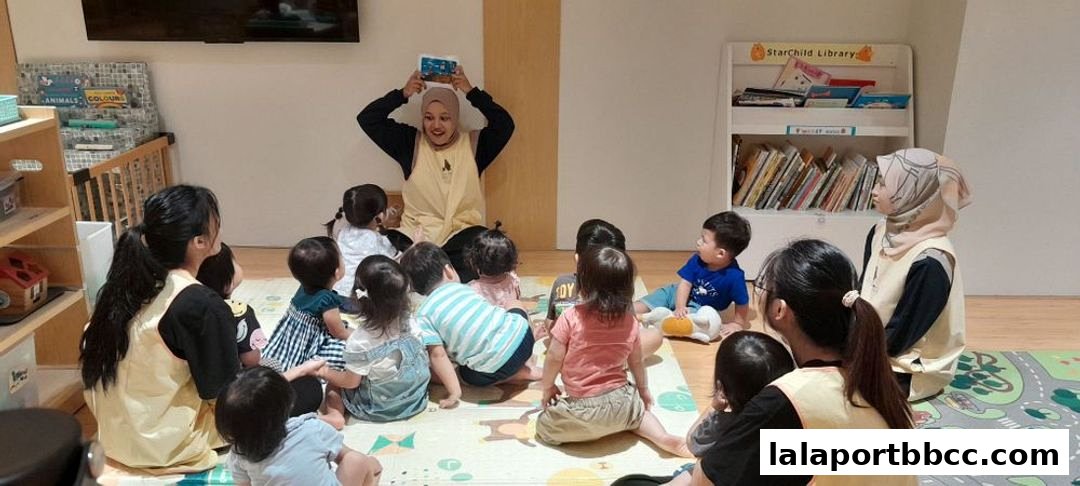 A teacher reads a book to a group of young children sitting on the floor.