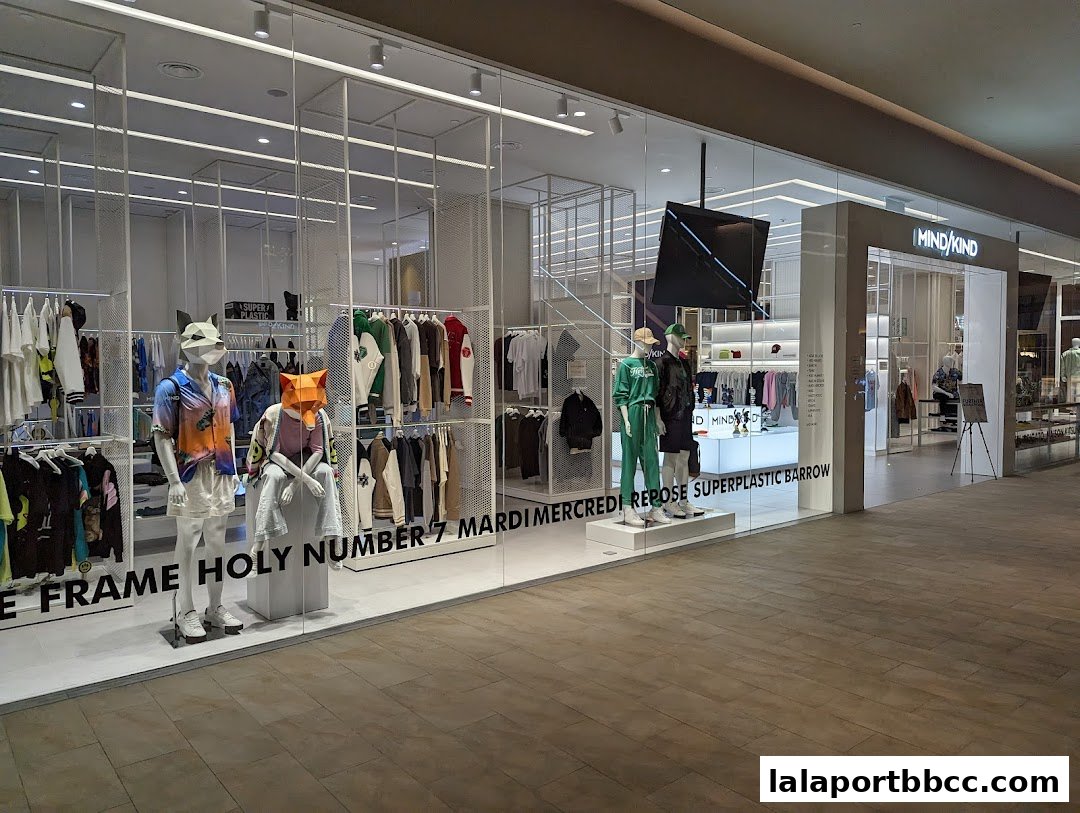 A modern clothing store with mannequins displaying trendy outfits and racks of apparel.