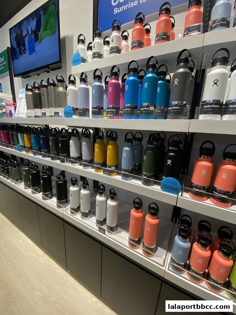 A wide selection of Hydro Flask bottles displayed on shelves in various colors and sizes.