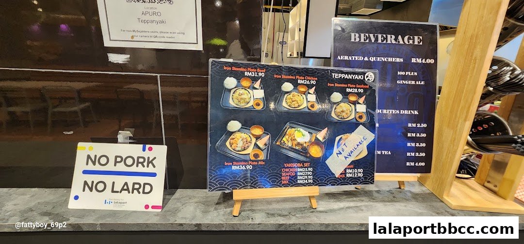 A menu board displays teppanyaki dishes and beverages, with a 'No Pork, No Lard' sign.