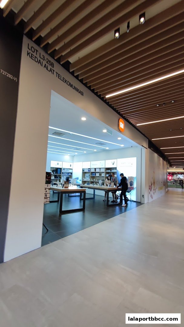 The entrance of a modern Xiaomi electronics store with products displayed inside.