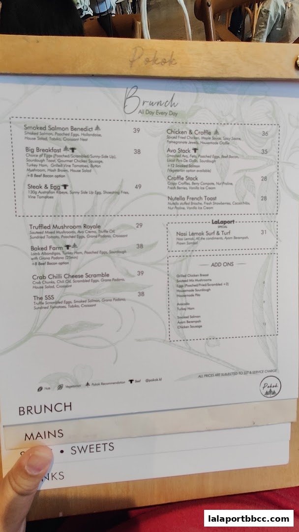 A menu from POKOK LaLaport featuring brunch items, mains, and sweets.