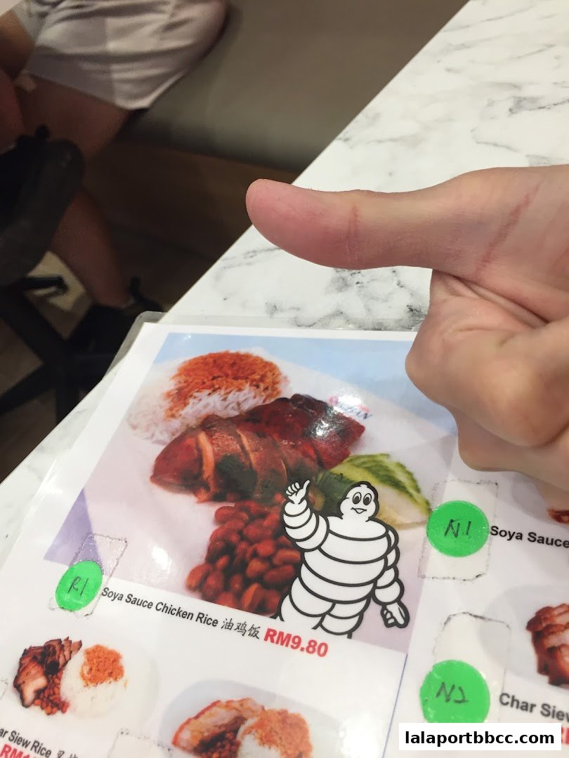A menu item for Soya Sauce Chicken Rice with a Michelin Man sticker.