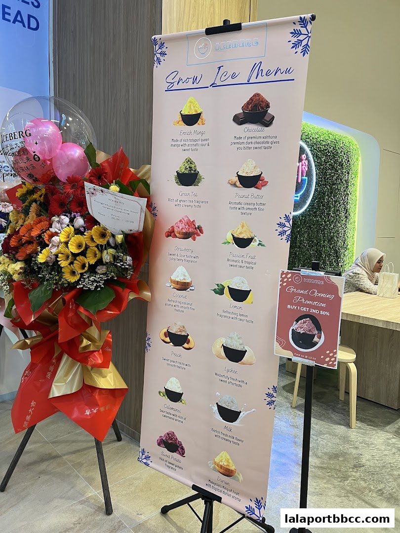 A menu board for Iceberg Snow Ice featuring various flavors like Mango, Chocolate, and Durian.