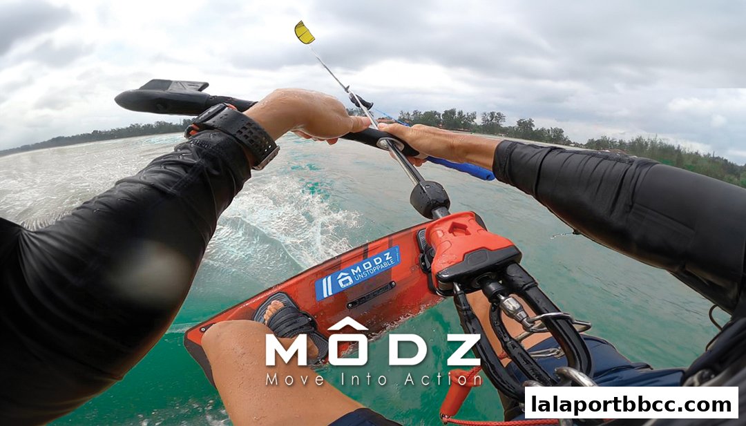 First-person view of someone kitesurfing with the MODZ logo visible on the board.