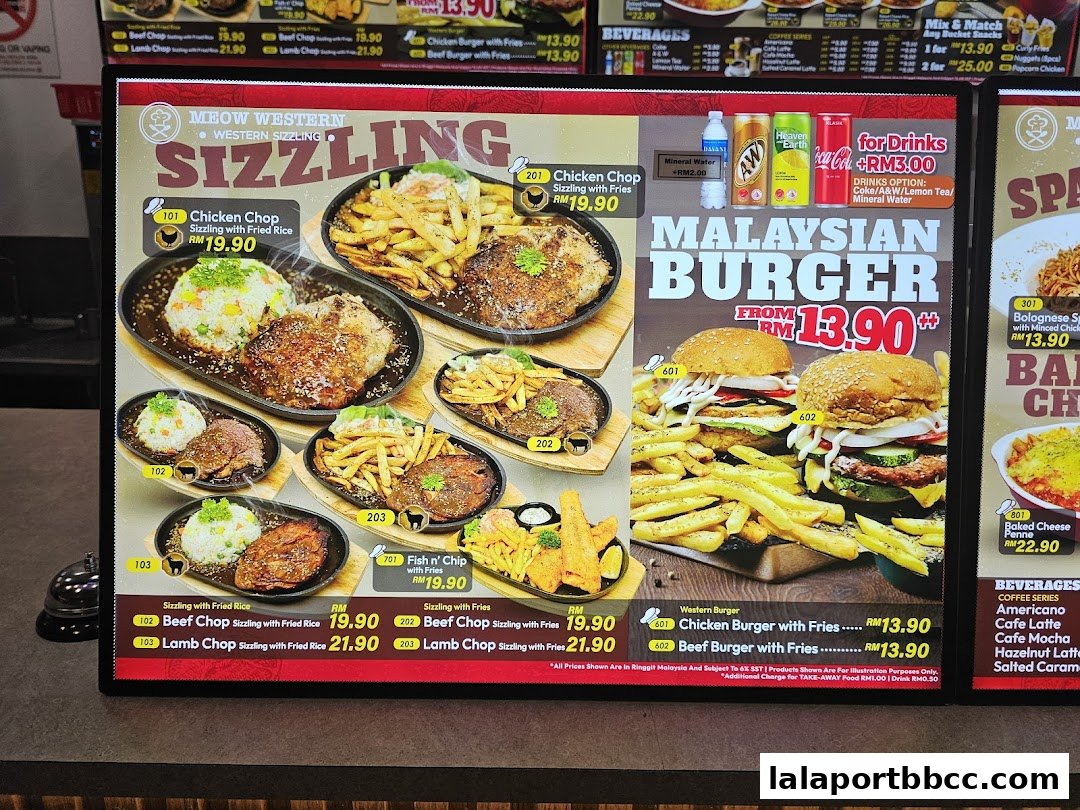 A digital menu board displaying sizzling Western dishes and Malaysian burgers with prices.