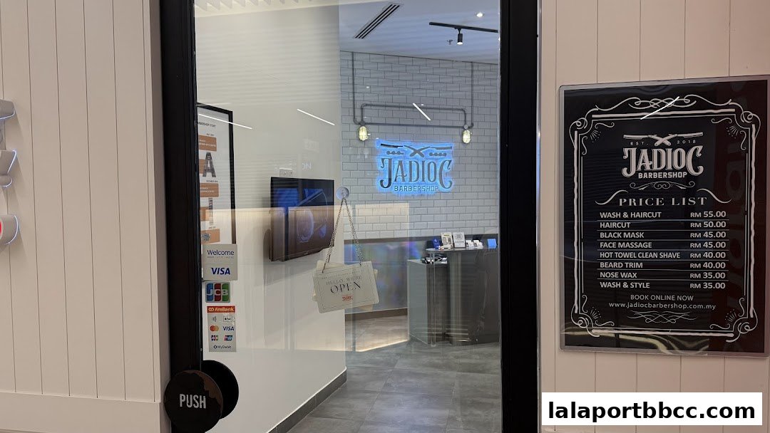 The entrance to Jadioc Barbershop with a price list displayed on the right.